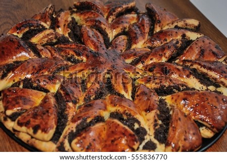 Butter Rich Christmas cake with poppy seeds in the form of eight-pointed star, with a glossy crust, korovay