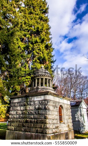 Exterior daytime stock photo of crypt in Mount Hope Cemetery in Rochester, York with cloudy blue sky in background.