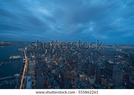 New york city and manhattan skyline at dusk with cloudy sky and lights. Photographed from the Freedom Tower 