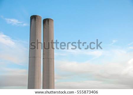 Cylindrical concrete columns over blue sky background