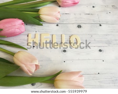 Sweet spring morning with tulips. hello spring, Valentines day wallpaper with tulips and hello word on white wooden background. Rustic pink tulips.