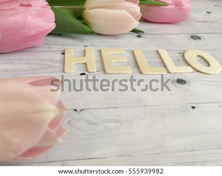 Rustic pink tulips.Sweet spring morning with tulips. hello spring, Valentines day wallpaper with tulips and hello word on white wooden background. 