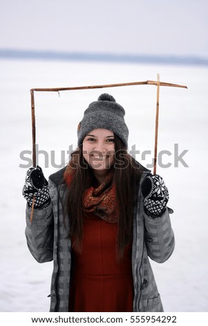 Pretty young girl in an wooden frame 