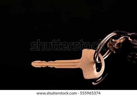 a key and a compass on a black background