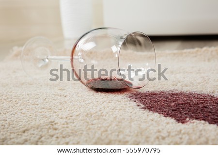 High Angle View Of Red Wine Spilled From Glass On Carpet Royalty-Free Stock Photo #555970795