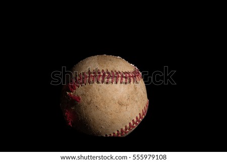 Tattered baseball on a black background
