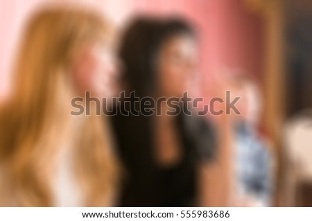 Group Of Female Friends Enjoying Evening Drinks In Bar theme creative abstract blur background with bokeh effect
