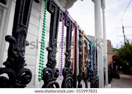 Mardi Gras beads on an iron fence in the New Orleans French Quarter