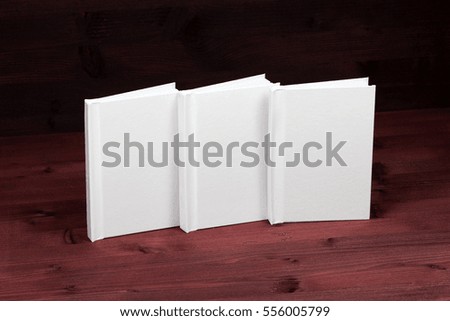 Blank clean white book on a red colorful wooden background