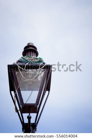 Mardi gras beads on a gas lamp in the New Orleans french quarter