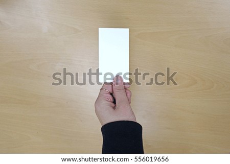 Hand handing a blank business card