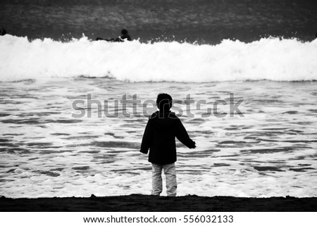The boy looking at a winter sea/I took a picture at a beach in Japan Kanagawa-ken Oiso-machi in January