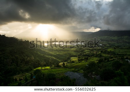 Beautiful sun rays through the clouds over mountains.(golden light)