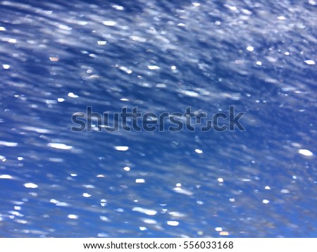 Water spray with a blue sky behind it.