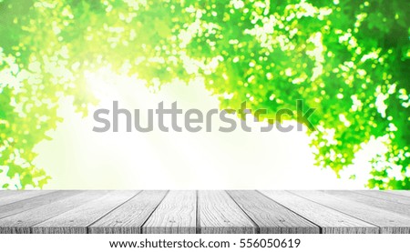 Wooden tabletop with blurred of nature with bokeh background use for products or something display