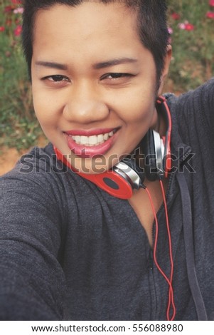 Woman taking a selfie with earphone
