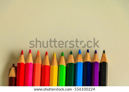 Wooden colorful pencils on white table.