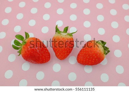 three strawberry on pink