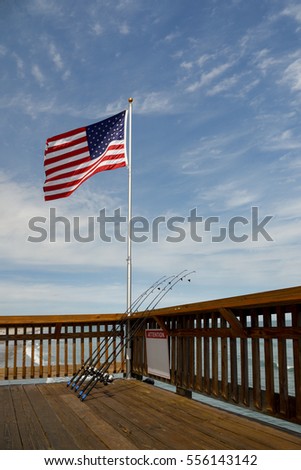 America flag on a pier with equipment for rent to going fishing-Florida