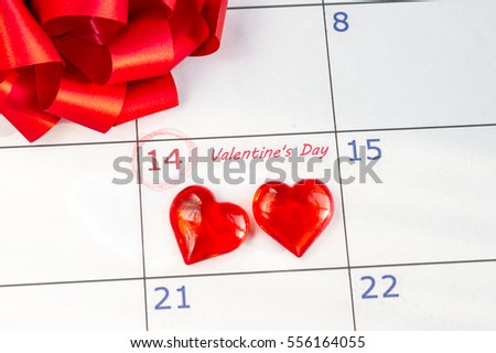 Valentine's Day on February 14 on the calendar two red love heart, red bow. Holiday lovers. The celebration, gifts.