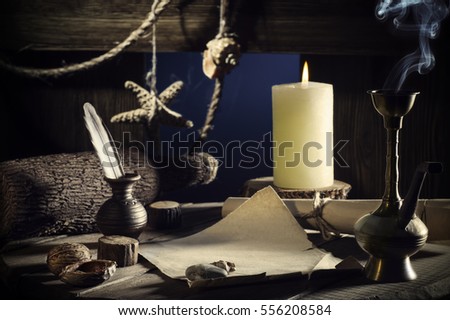 Vintage concept of sea travel, writing a letter on a wooden keg with a burning candle, smoking a hookah. Message in a bottle on old paper. Cabin wooden vessel, close-up, a pirate ship. Sea adventure.