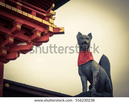 low light style with old fox statue at fushimi inari japan