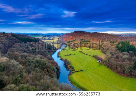 View over river wye and Coppet hill from Symonds Yat rock in Herefordshire January 2017 as the sun behind was setting Royalty-Free Stock Photo #556235773