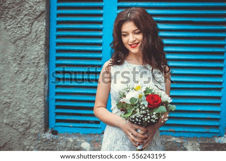 beautiful bride at a wall