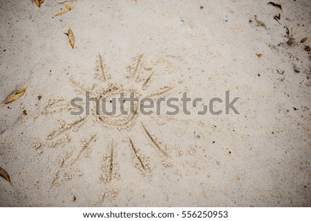 Sun Drawn in the Sand on a Beach