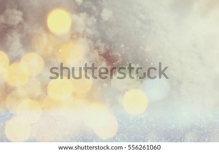 glitter lights background. silver, gold and white. de-focused