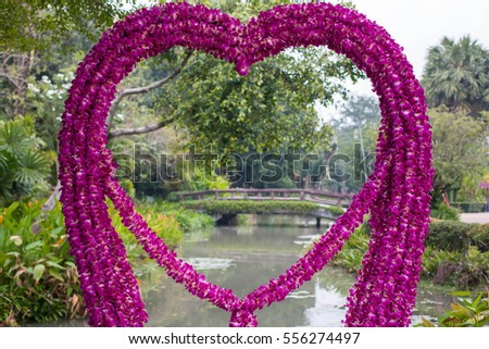 Orchid heart arch in garden background