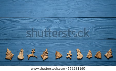Christmas cookies on the blue boards: snowman, santaclaus, star, tree, deer, man