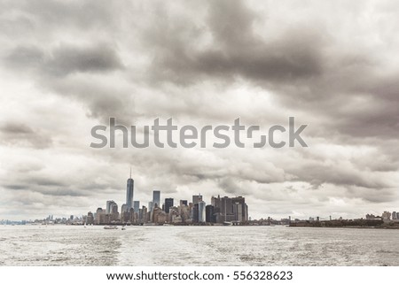 New York, Downtown Manhattan epic view from the river. Wide angle photo of lower Manhattan on a cloudy stormy day. Empty space to add text on top.