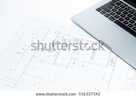 Notebook over house construction blueprint with blue tone effect, useful for construction, business, architecture, engineering, insurance background concepts