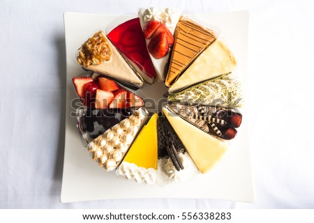 Topdown view of cakes, strawberry, cheese, chocolate, blue berry, coffee cakes taken outdoor with natural lights Royalty-Free Stock Photo #556338283