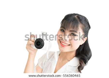 Portrait of a young smiling woman take a photo on white