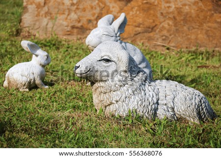 Sheep statues and Rabbit statue on the green lawn.