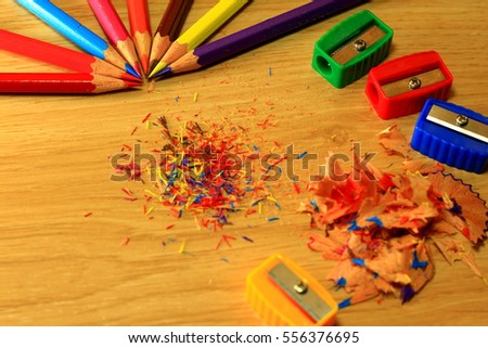 Sharpening a color pencil sharpener On the wooden floor.