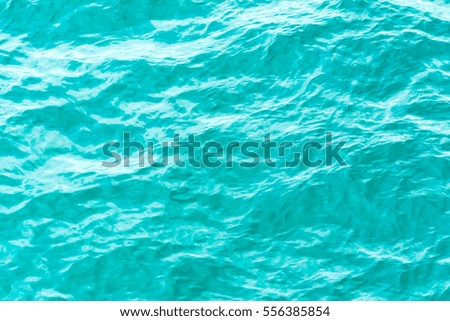 Blue sea and a moving reflection of sunlight