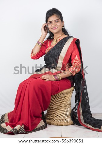 Happy young beautiful traditional Indian woman in saree.
