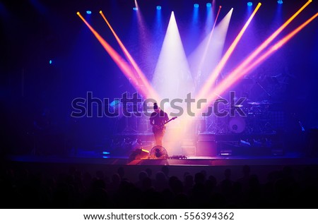 Guitarist performing on stage. Concert. View from the auditorium. Royalty-Free Stock Photo #556394362