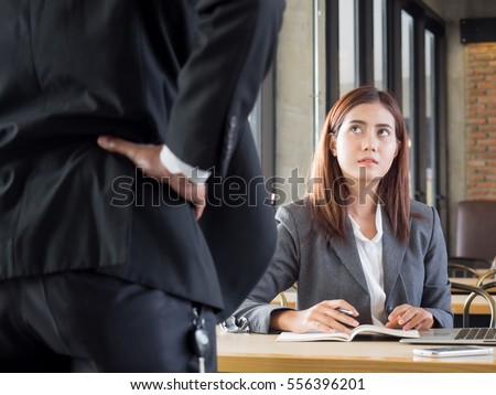 Aggressive/angry boss complaining asian business woman(casual uniform) in cafe office Royalty-Free Stock Photo #556396201