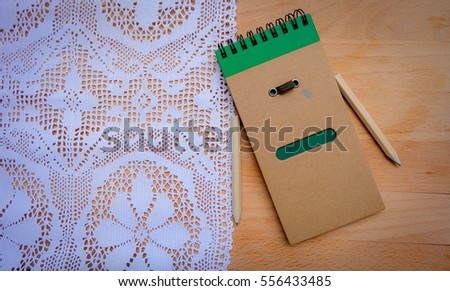 Sad face and crying textbook on wood background.Top view space for text and background for give up quotes.memo book.for bad valentine.
