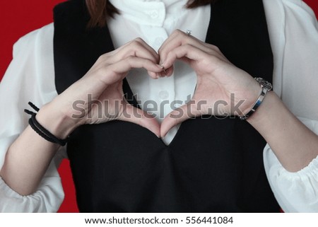 Woman made heart symbol.