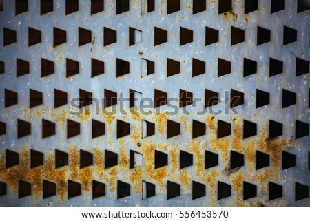 Pentagon shape holes in grey metal sheet abtract texture background