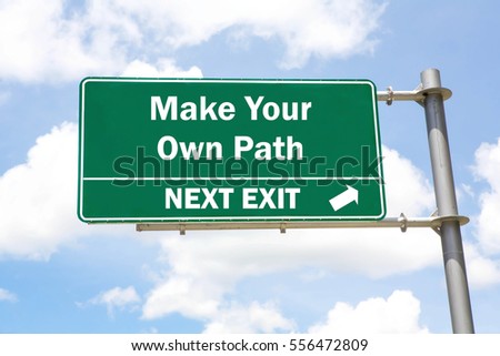 Green overhead road sign with a Make Your Own Path Next Exit concept against a partly cloudy sky background.