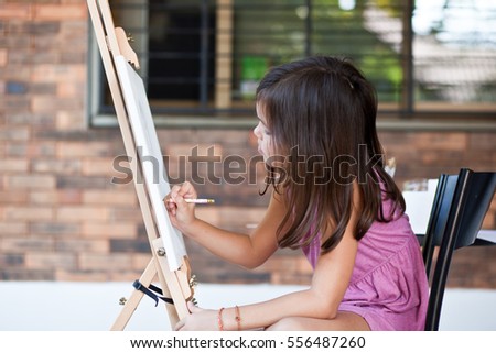 The little girl draws a picture