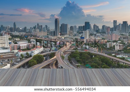 Opening wooden floor, Bangkok city background over highway intersection, Thailand
