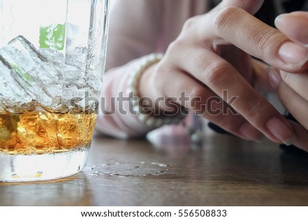 Abstract concept image of woman hand with cola glass in cafe and use a mobile phone playing social network selective focus