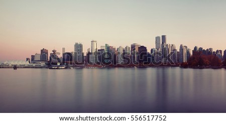 Vancouver downtown architecture and boat with water reflections at sunset panorama
